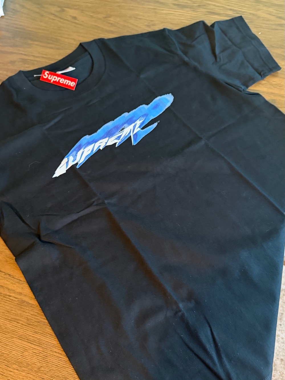 Supreme Black Short-Sleeve Tee with Blue Script Graphic